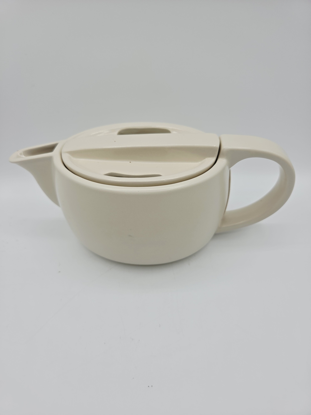 Cream Ceramic Teapot with Integrated Lid and Handle